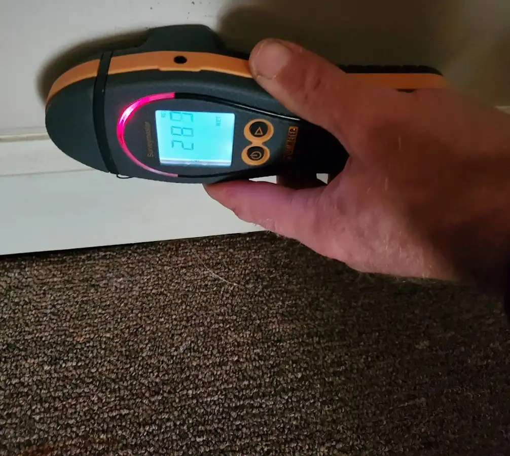 Moisture detection at baseboard during Storm Damage Restoration in Georges